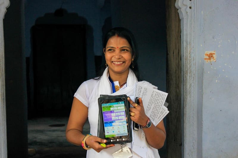 Healthcare professional holding an iPad.