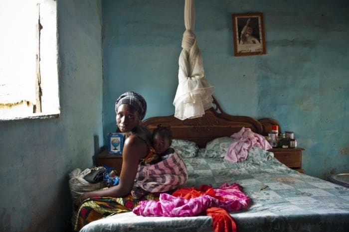 woman and child sitting on the bed