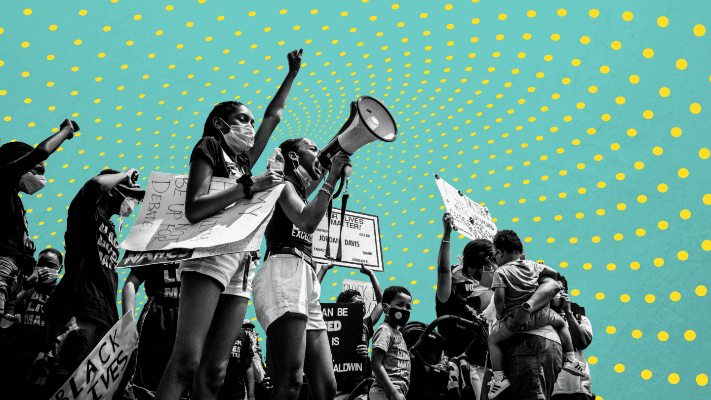 A group of young protesters walking down the street.