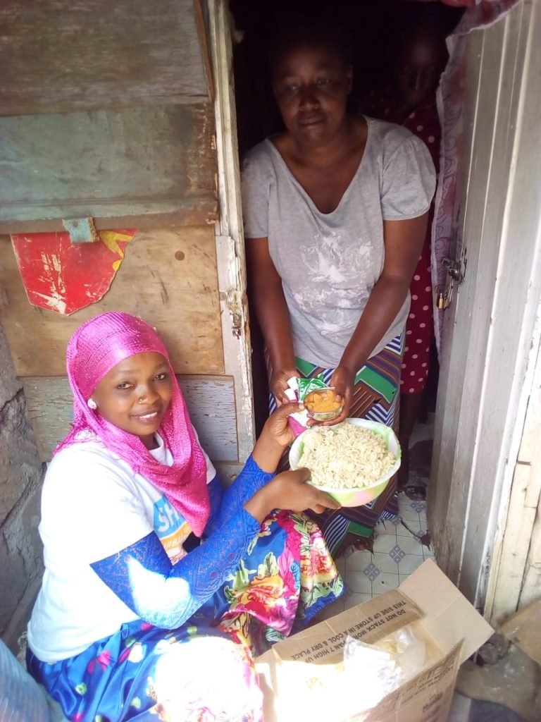 Woman serving another woman food.