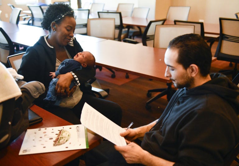 A woman and baby receive family EITC tax benefits.