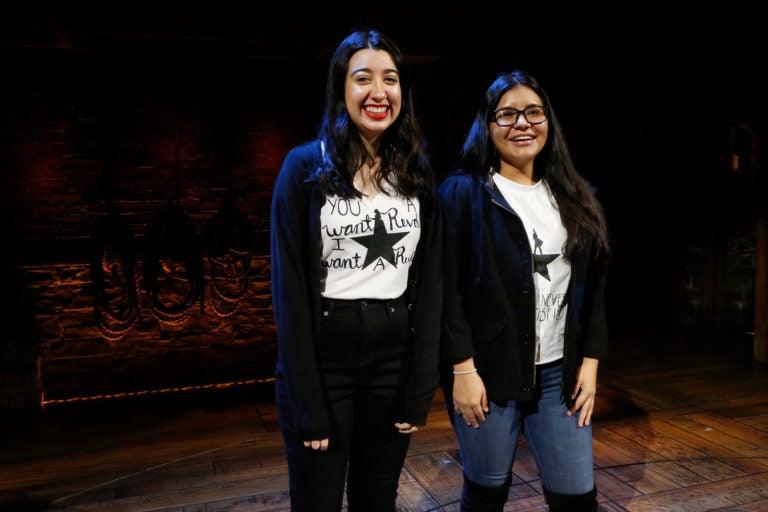 Two female high school students standing on the set of Hamilton as part of the Hamilton Education Program.