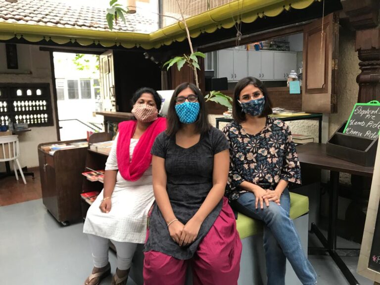local women entrepreneurs in India at their bookstore wearing face masks due to covid
