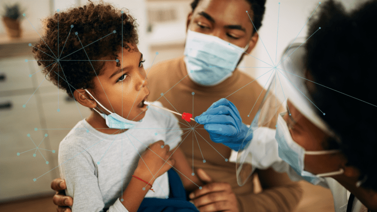 young male child getting swabbed in the mouth by a woman in protective gear