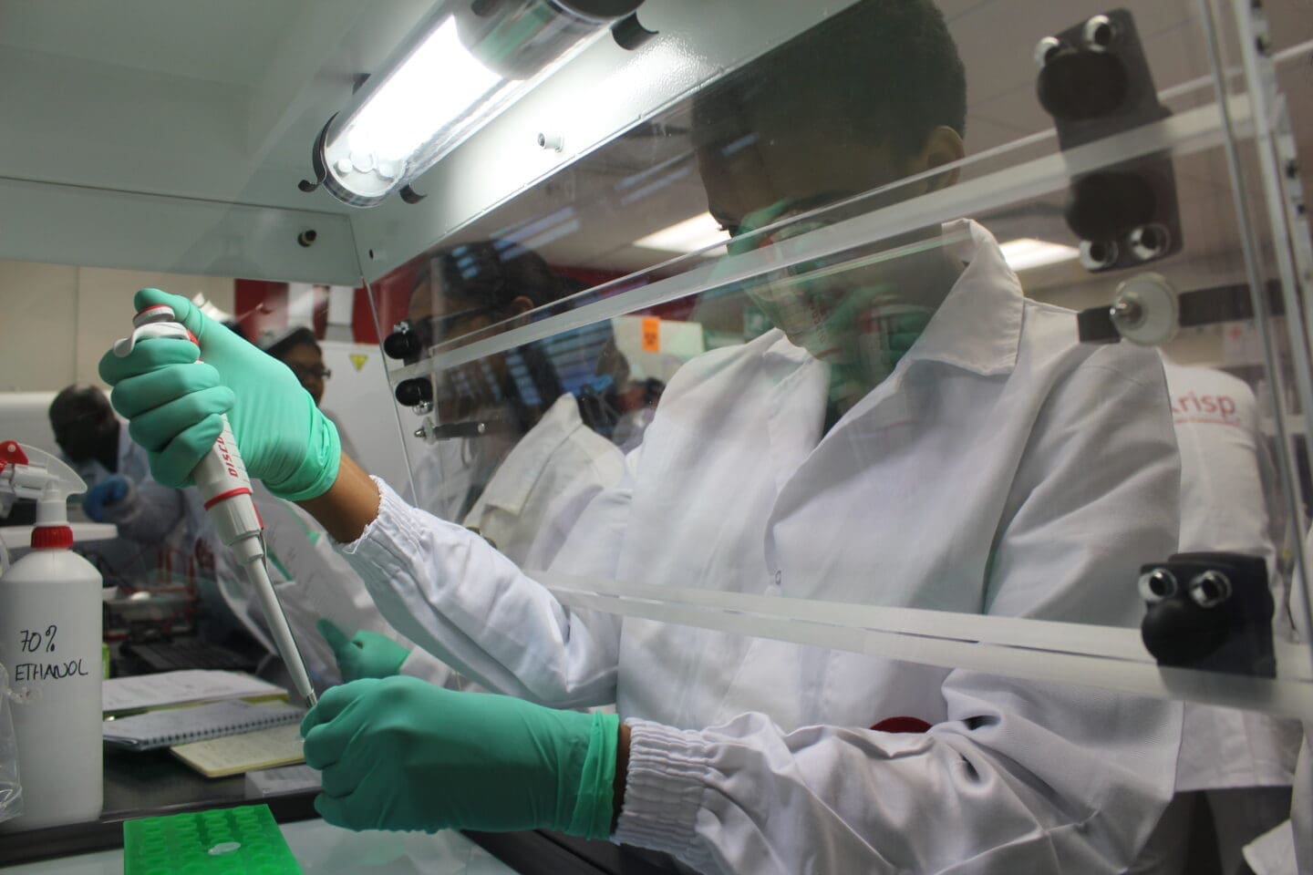 man in white lab gown and gloves