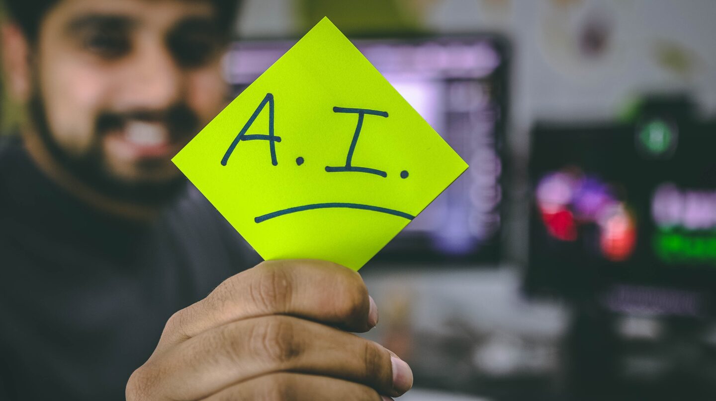 guy holding a sticky note that says A.I.