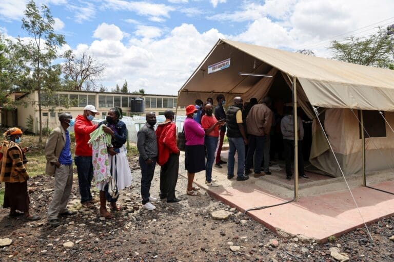 people standing in line to receive a Covid-19 vaccine.