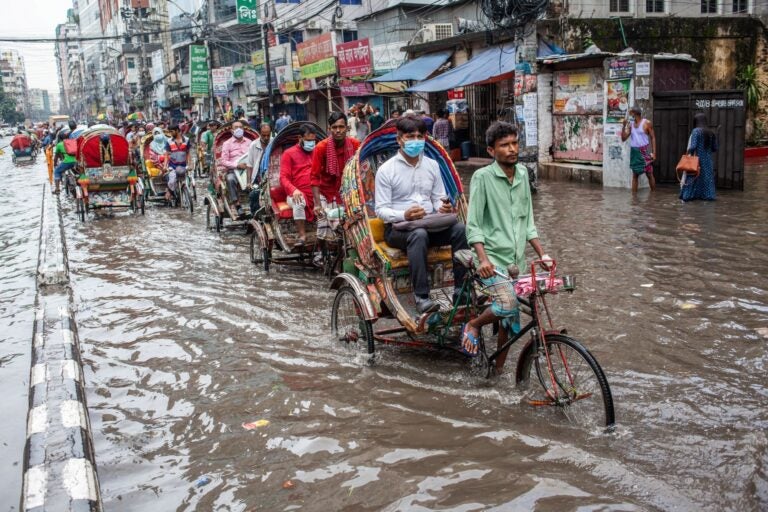 people biking through a flood.