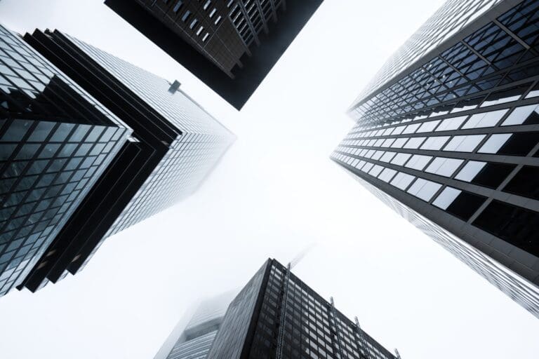 looking up at tall buildings into the sky