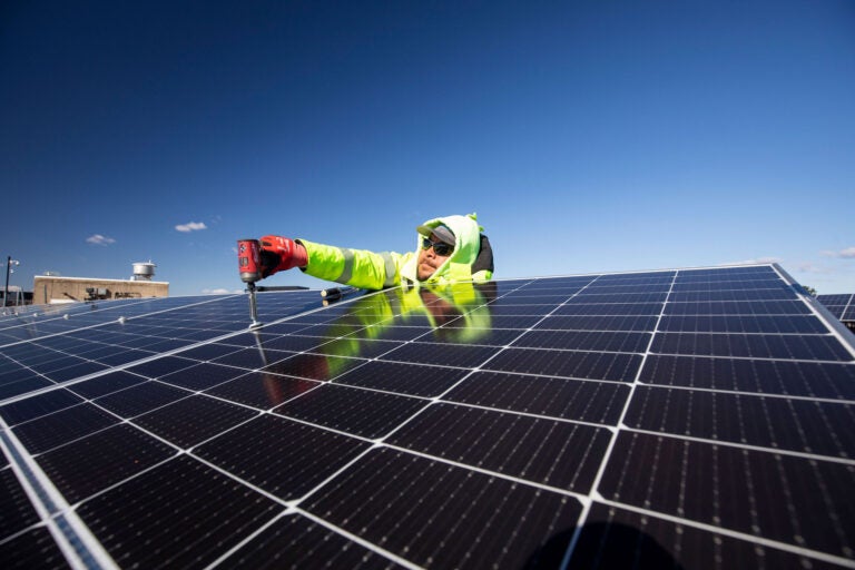 man working on solar panels.