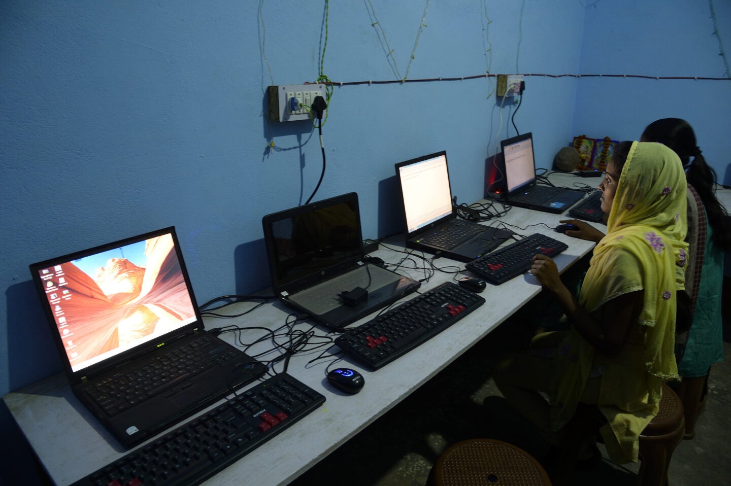 Women working in an internet cafe powered by mini-grid solar panels (Photo Courtesy of SPI)