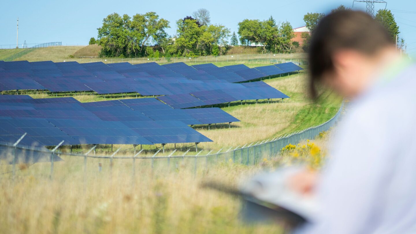 Man recording data from a solar farm