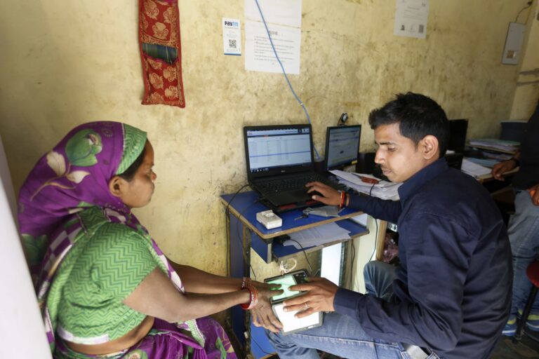 With the help of electricityy, a woman is registering for a national identity card in the town of Atrali, Uttar Pradesh, in 2015 (Photo Courtesy of SPI)