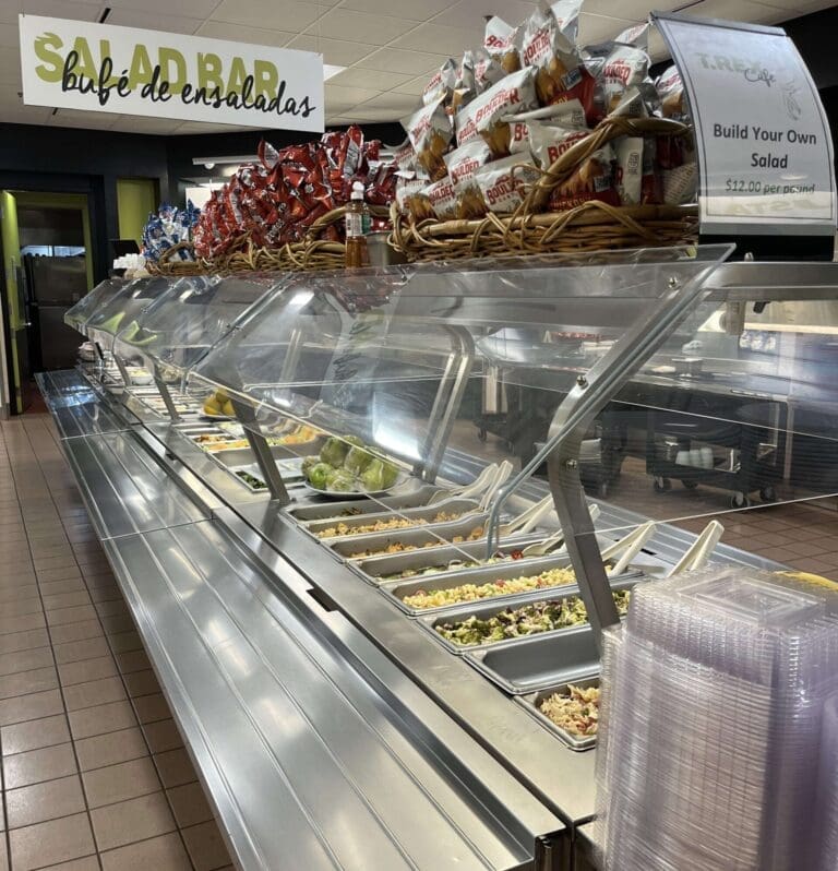 fruit and salad laid out at a salad bar