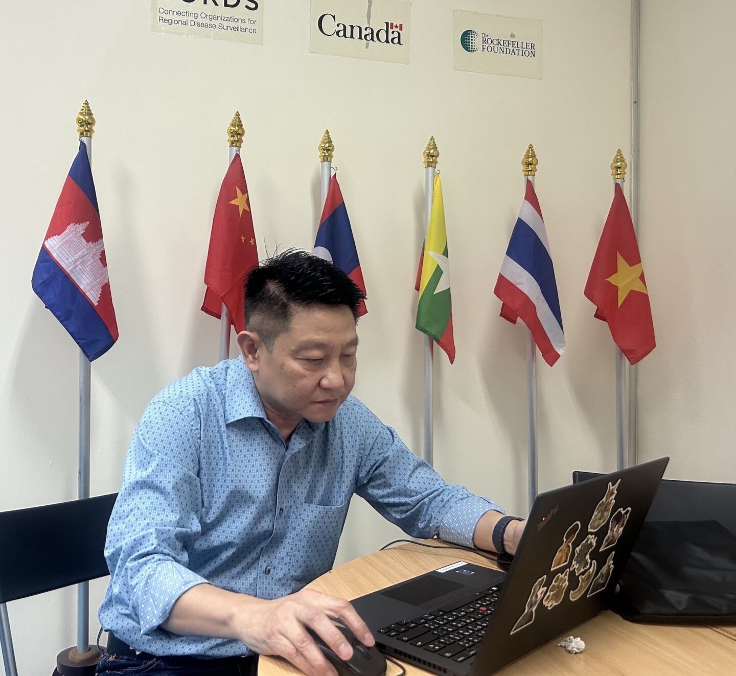 Dr. Oo at work in his MBDS office in Thailand 2023 (Photo Credit Masha Hamilton)