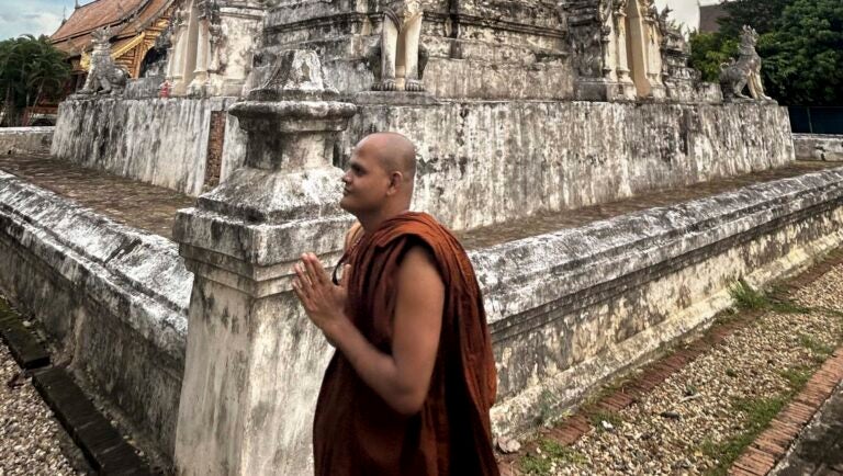 Bangladeshi monk Priyabangsha Bhikkhu visits the Wat Chedi Liam temple during the _Building Bridges_ covening in Thailand (Photo Credit Masha Hamilton)