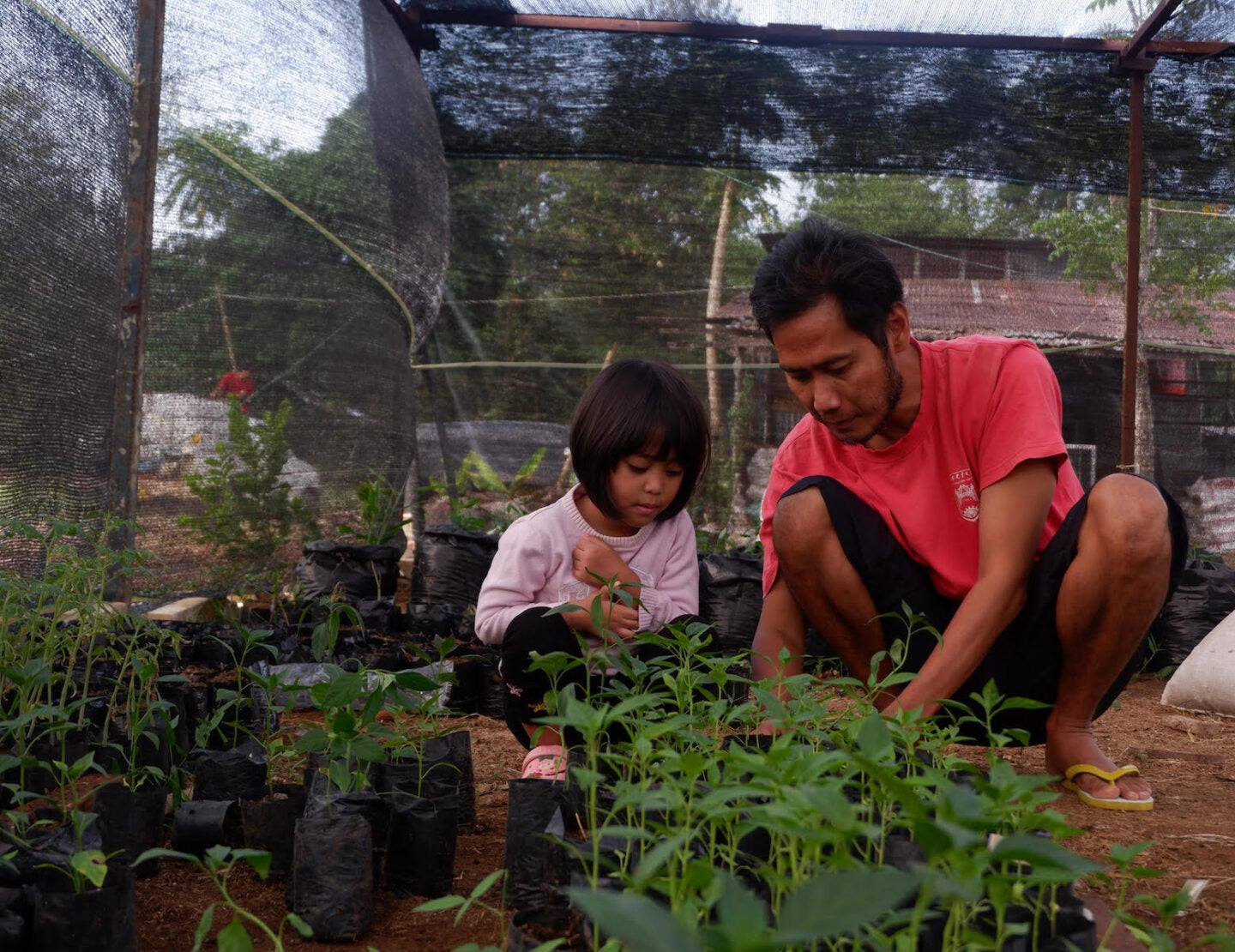Karno Batiran with one of his children at a collective learning center for farmers (Photo Courtesy of Karno Batiran)