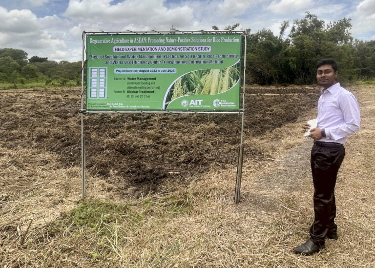 Sheikh Faruk Ahmed, an AIT student from Bangladesh, in front of field prepared for AIT's rice research, supported by The Rockefeller Foundation (Photo Credit Masha Hamilton)