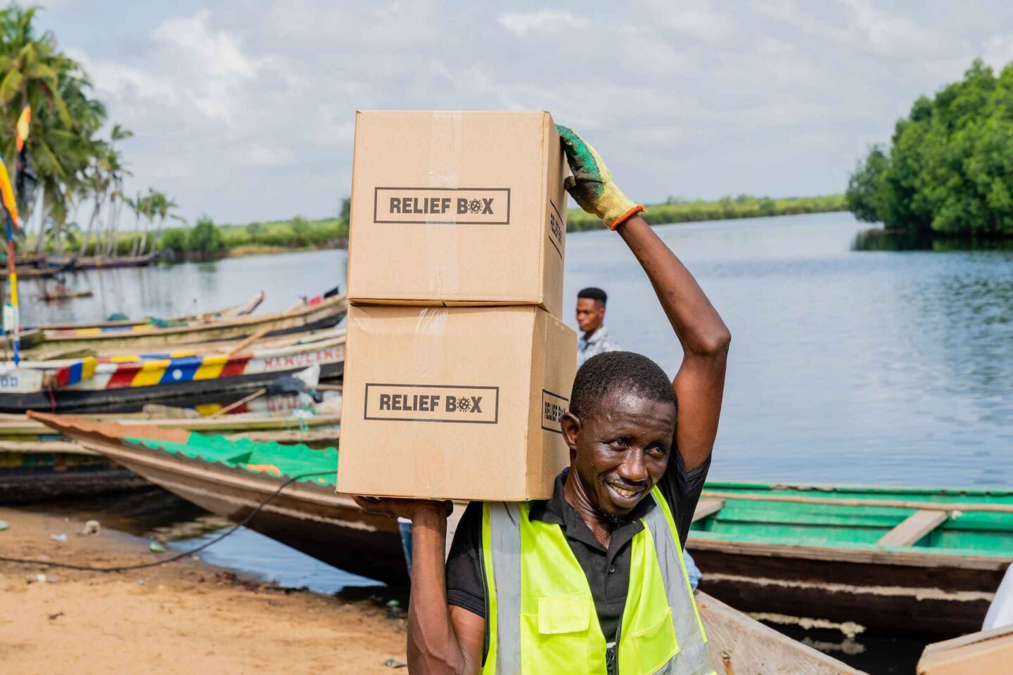 Ibrahim Jibril of Food For All Africa offloads food boxes to distribute in Ghanas Volta region impacted by an October 2023 dam spillage and flooding from monsoon