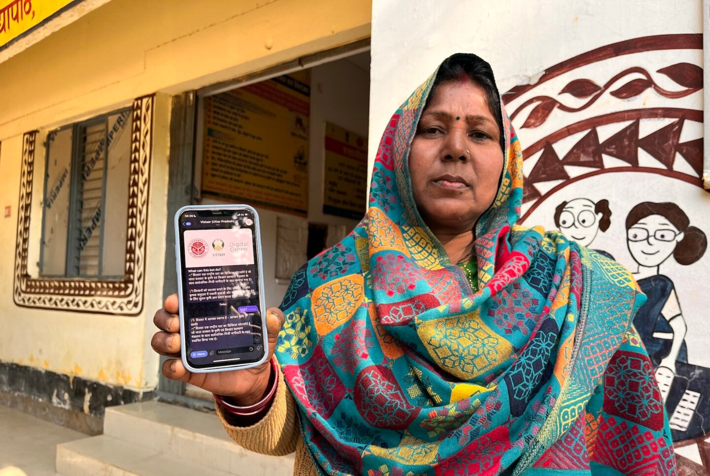 A farmer in Varanasi, Uttar Pradesh, displays Farmer.Chat, an AI-powered phone app which is transforming farming in India. (Photo Courtesy of Digital Green)