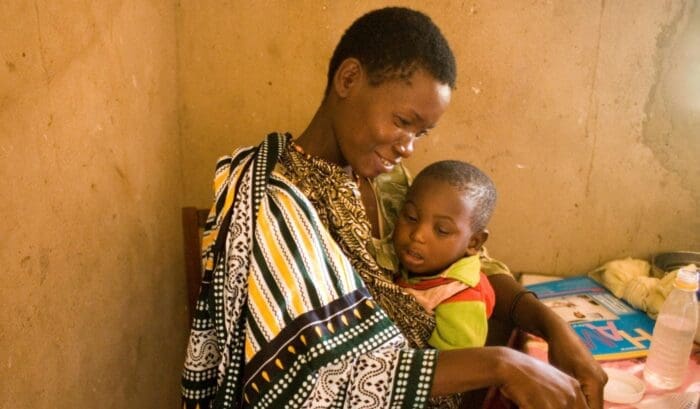 woman holding her child in her arms.