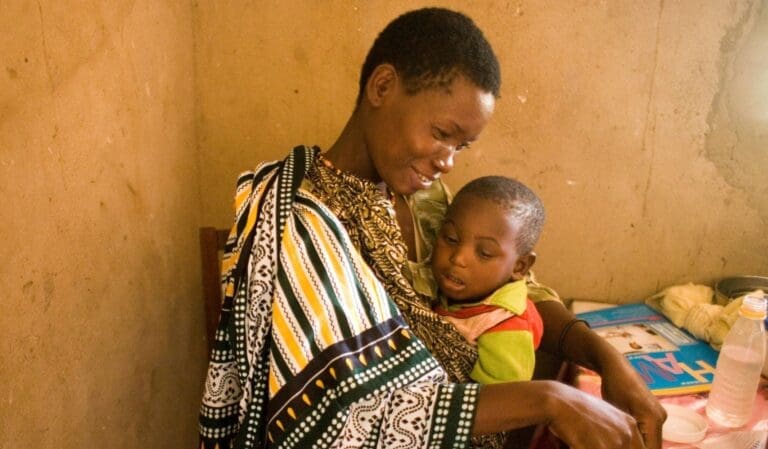 woman holding her child in her arms.