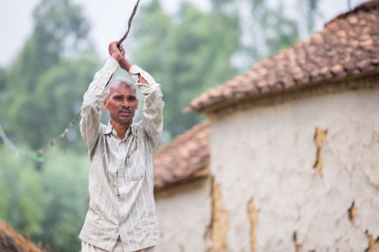 Man putting up electricity cables to form a mini-grind.