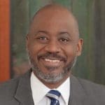 man wearing a suit and smiling