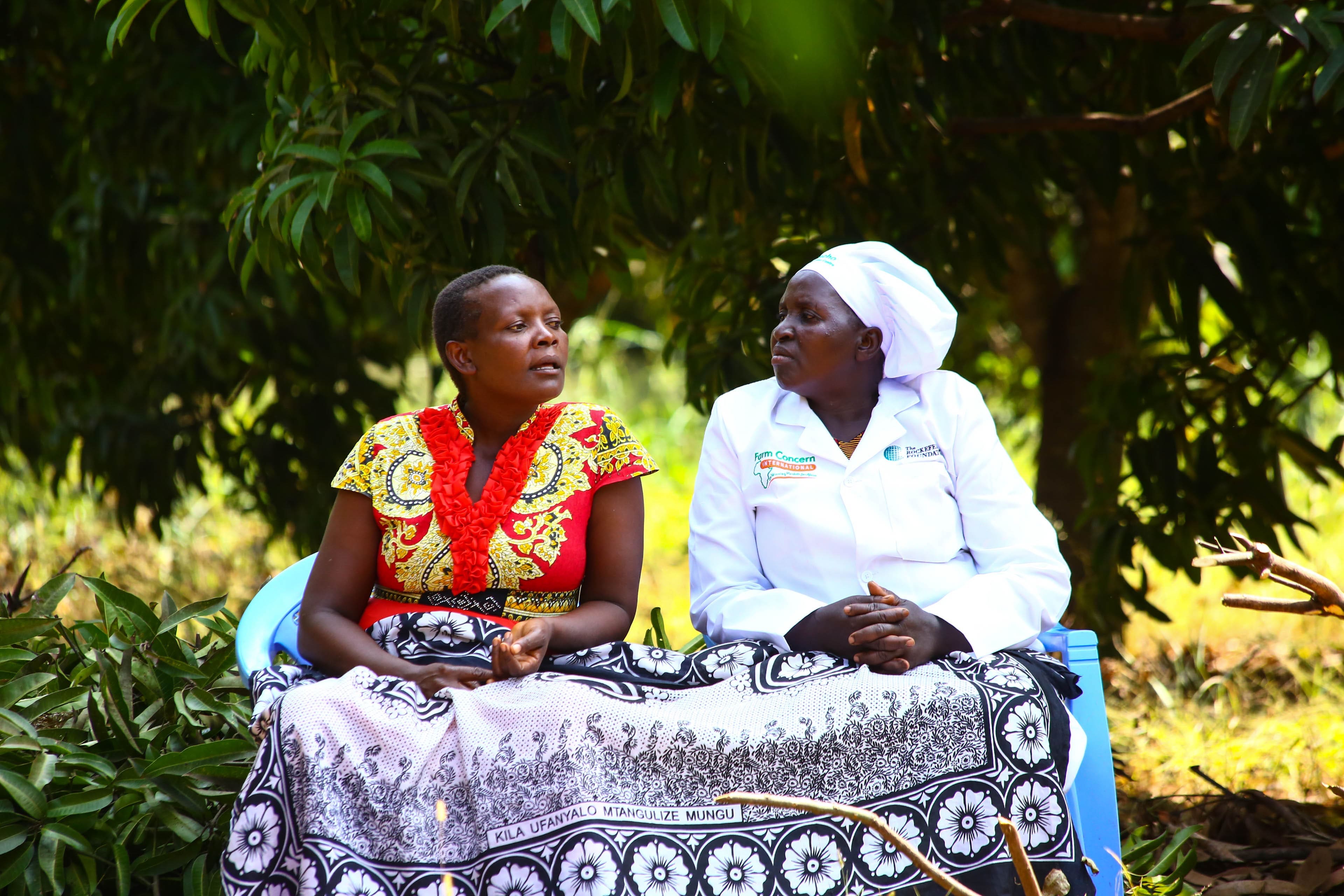 Two female members of the Karocho farmer group sitting together.