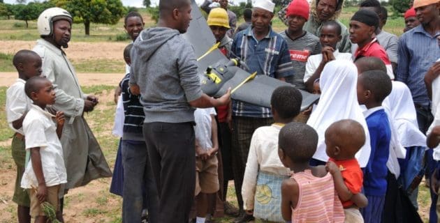 WeRobotics personnel conducting a drone demonstration for children in Tanzania.