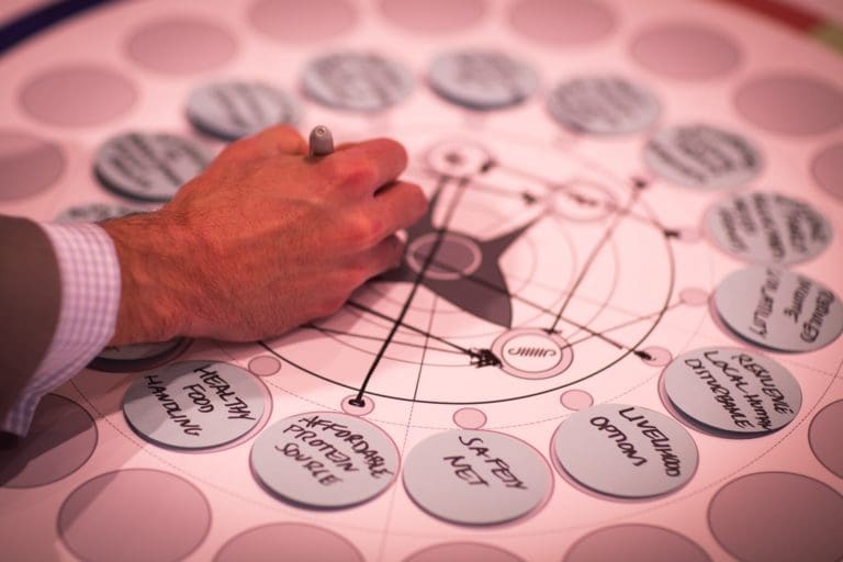 Man drafting a presentation with sharpie.
