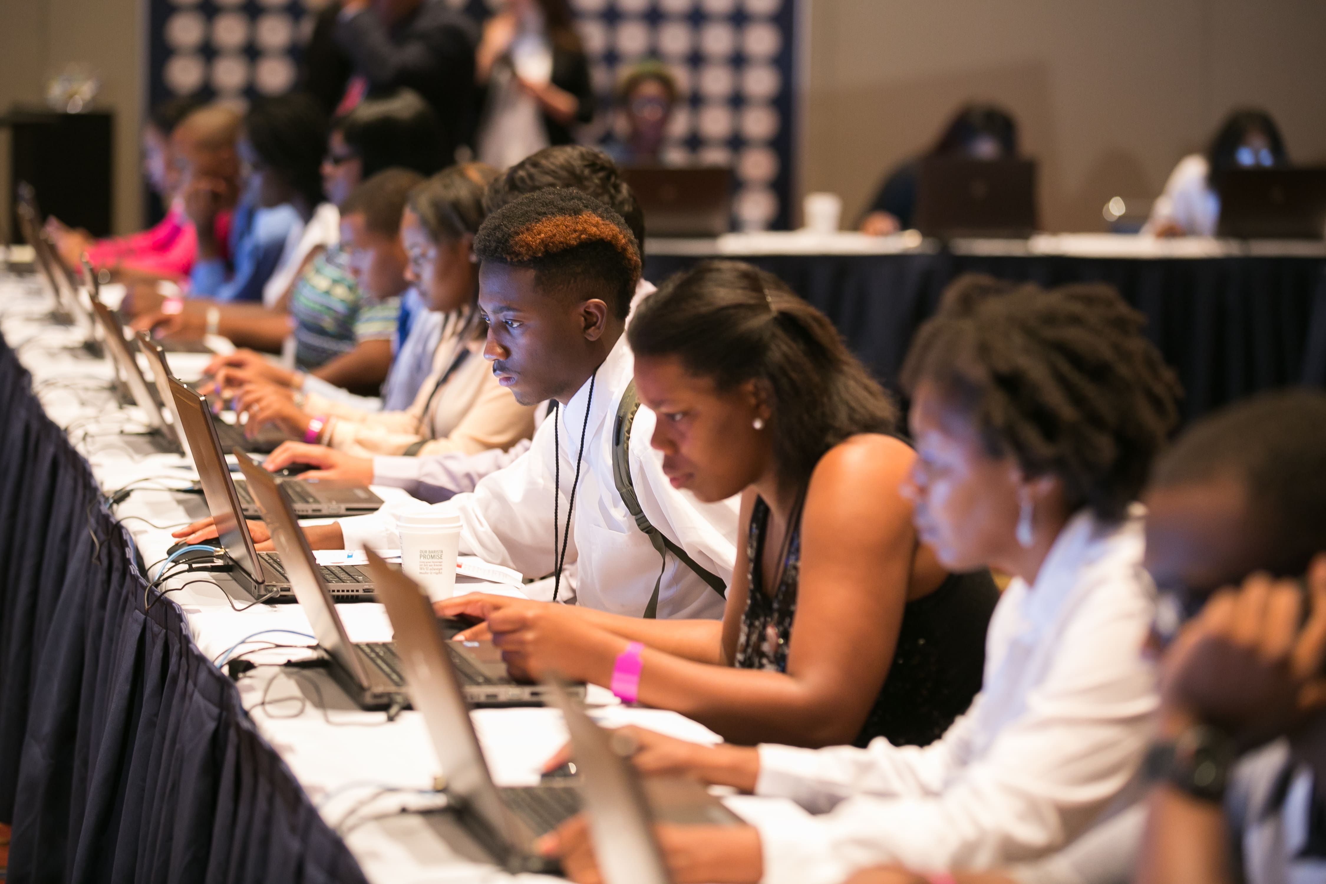 Youth filling out job applications at Opportunity Fair and Forum in Chicago