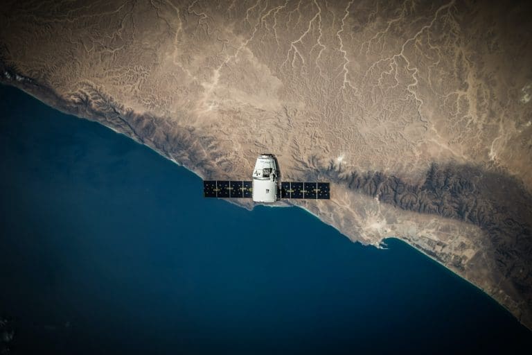 Satellite circling the earth.
