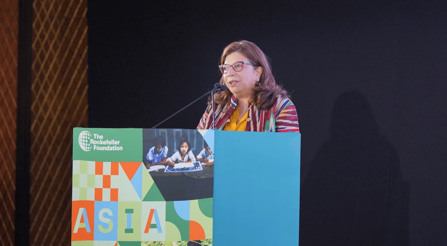a woman delivers a speech at a podium, engaging the audience with her presentation.