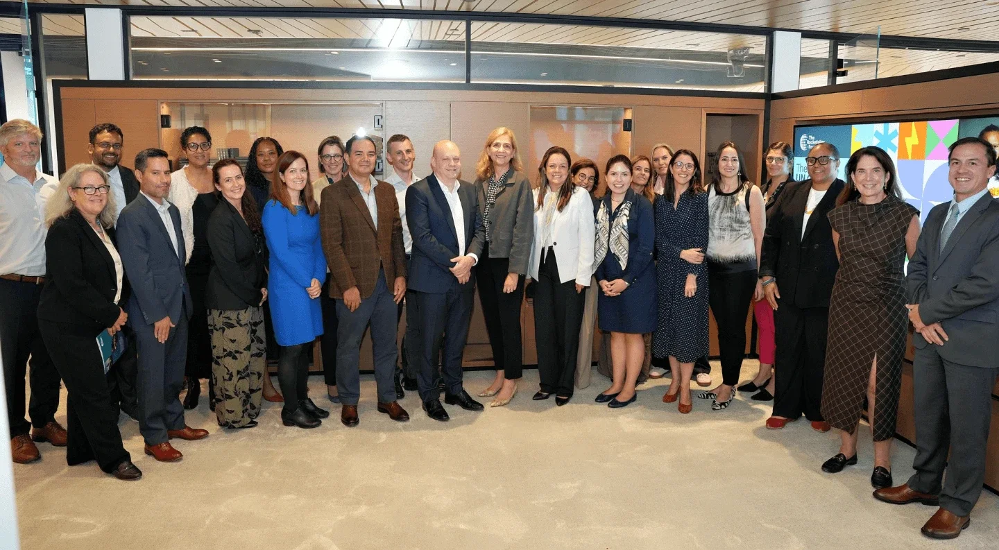 group photo of participants at a Rockefeller Foundation UNGA 2025 convening, with men and women standing together indoors and smiling for the camera.