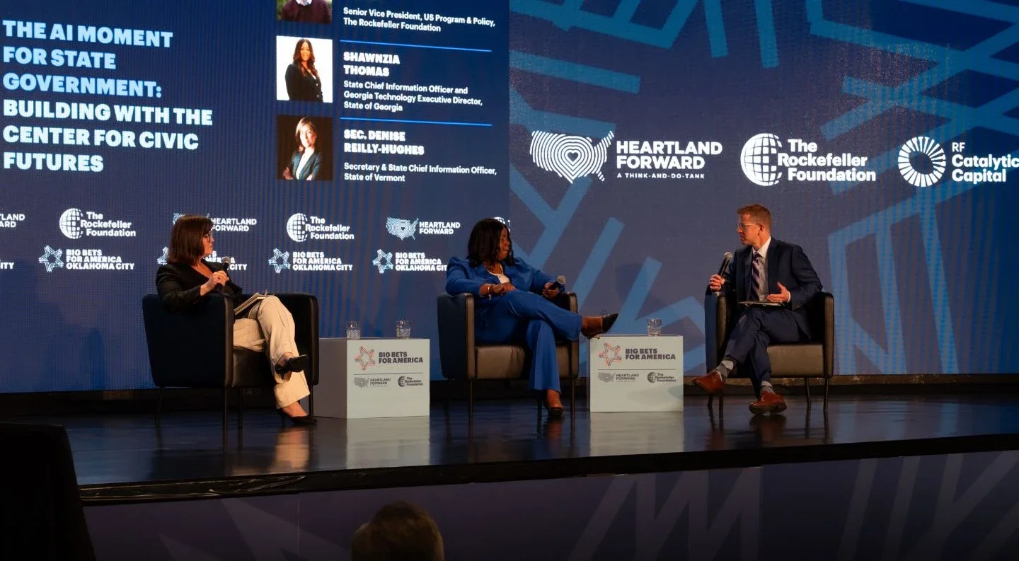 panel discussion on "The AI Moment for State Government: Building with the Center for Civic Futures" at Big Bets for America, featuring three speakers with panelist information displayed on the screen behind them.